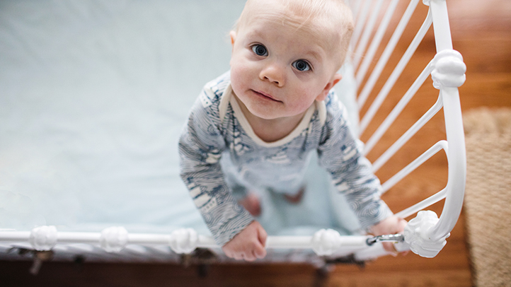 sleep regression, baby wide awake and standing in crib